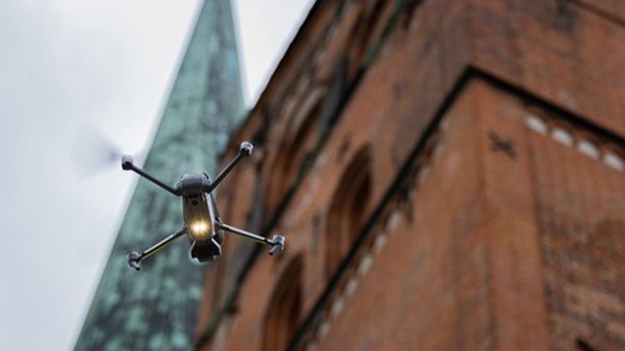 Eine Drohne fliegt vor dem Lübecker Dom.